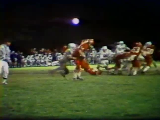 A boy tackles another player during a football game