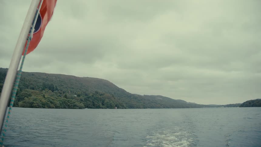 A boat drives through a lake