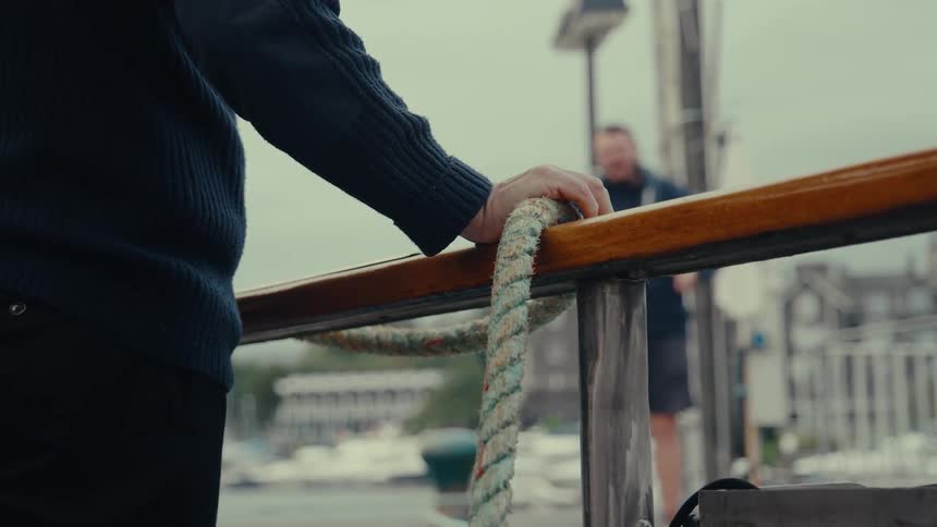 Person leaning on a boats handrail