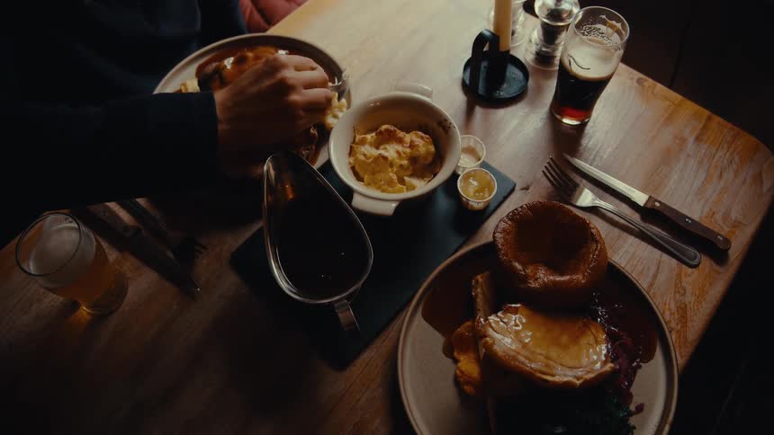 A man is eating at a restaurant