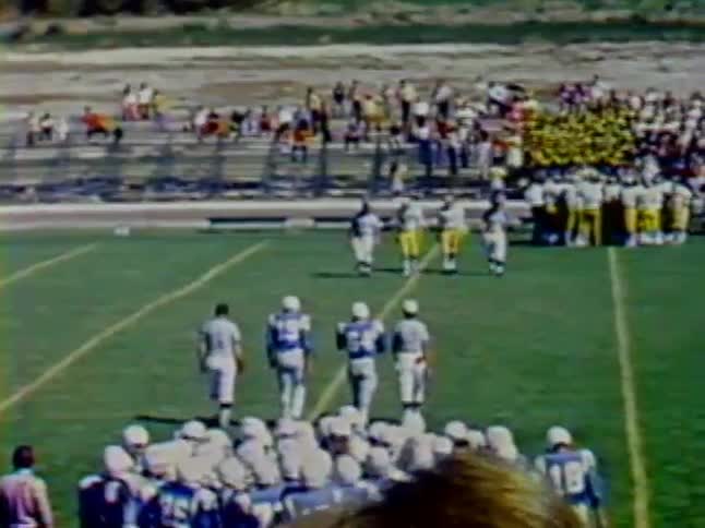 Football players walk across the field with the referees