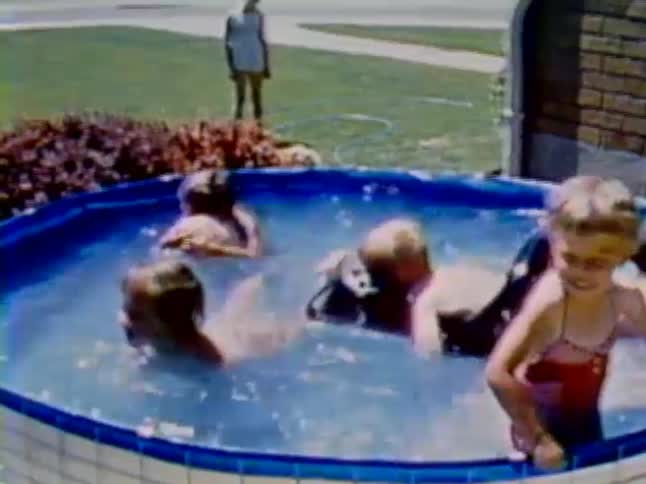 Children play and splash in a small swimming pool