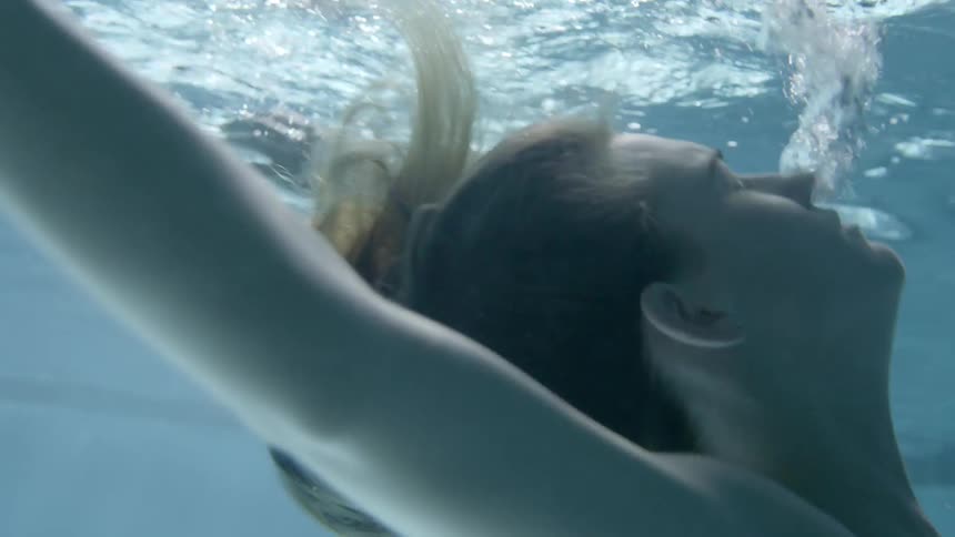 A woman floats in the pool