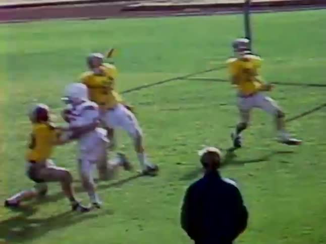 A football player charges ahead eventually getting tackled