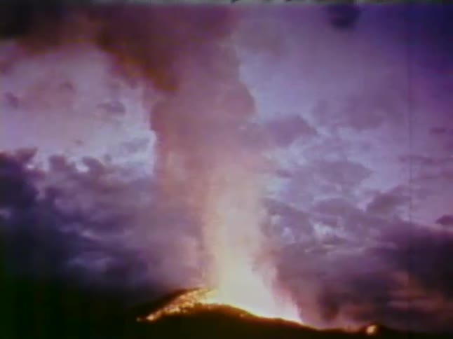 Lava raises in the distance giving off smoke