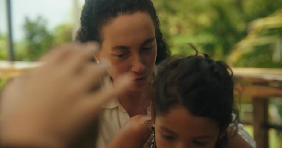 A young girl plays a block stacking game with her mother
