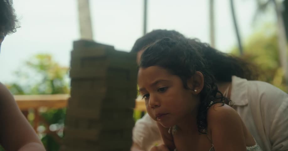 A family play a board game outside