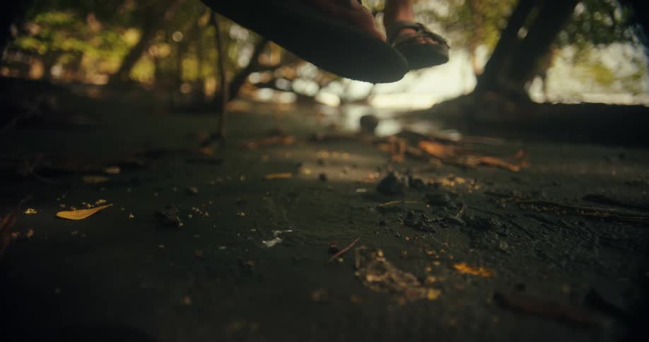People dangle their feet as paint dribbles to the ground below