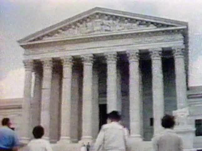 People walking up the stairs of a national monument
