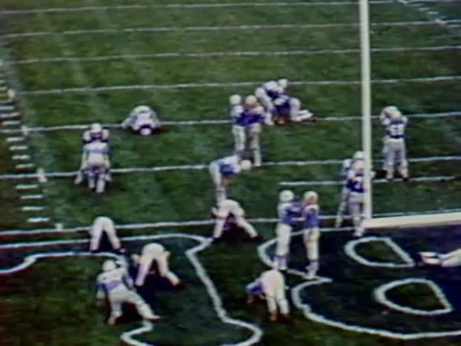 Football players line up for a play