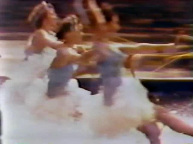 Four women are water skiing behind a boat