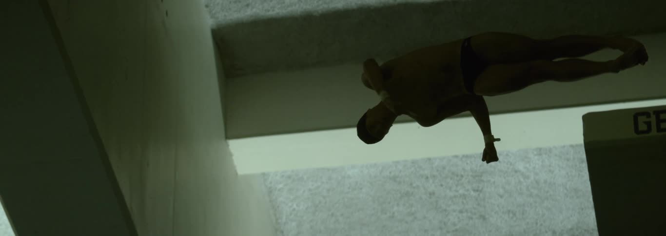 Male diver performs a dive starting near the ceiling
