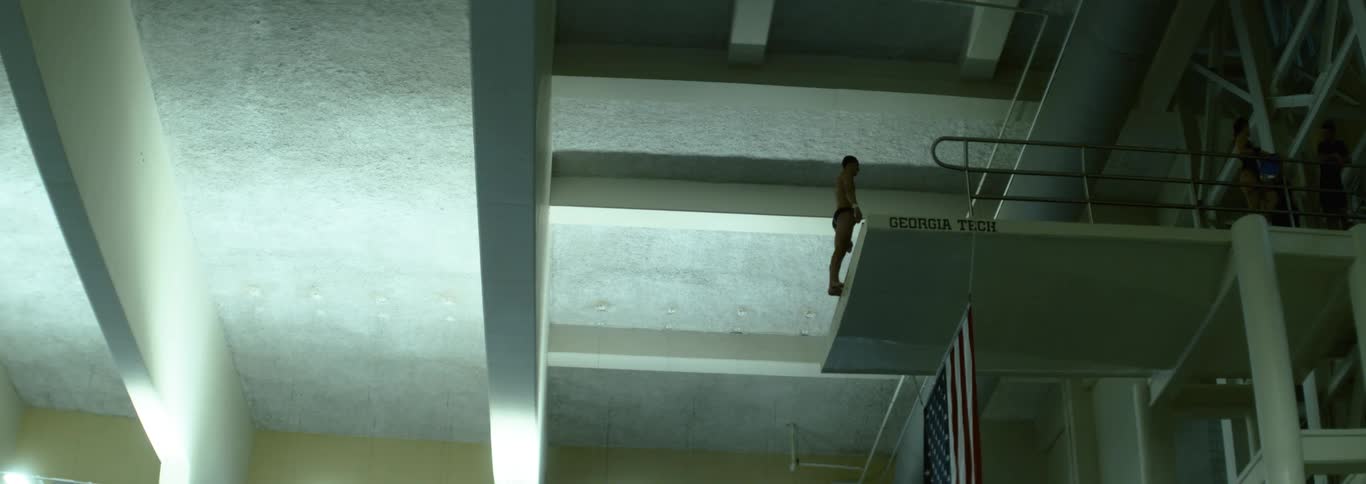 The man stands on the edge of the diving platform