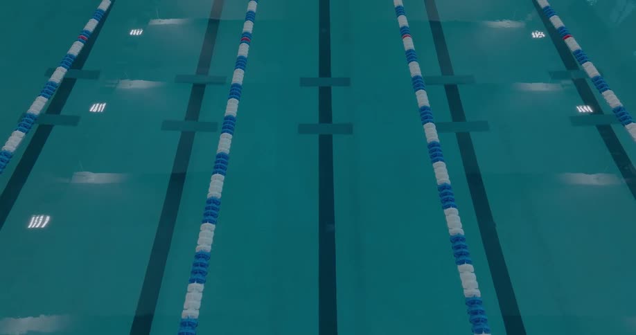 Blue and white lane ropes divide a deep swimming pool into lanes