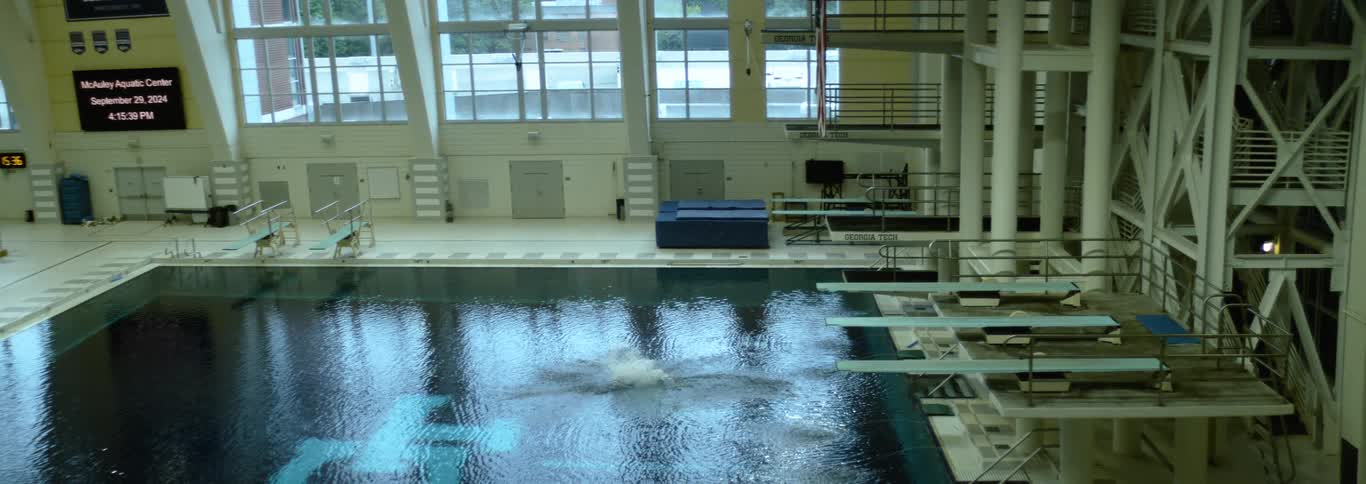 An indoor swimming pool with diving boards and lanes