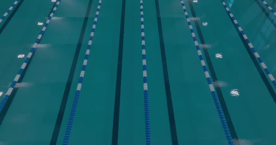 Olympic swimming pool with lanes marked by blue and white buoys