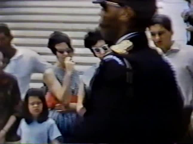 People are watching a guard with a rifle march