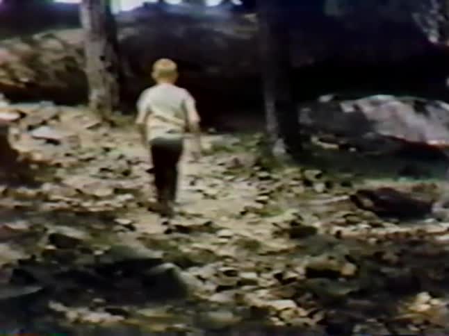 A young boy runs outside