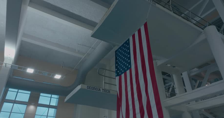 An american flag hangs under a high dive