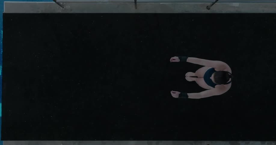 The woman is stretching on the diving platform