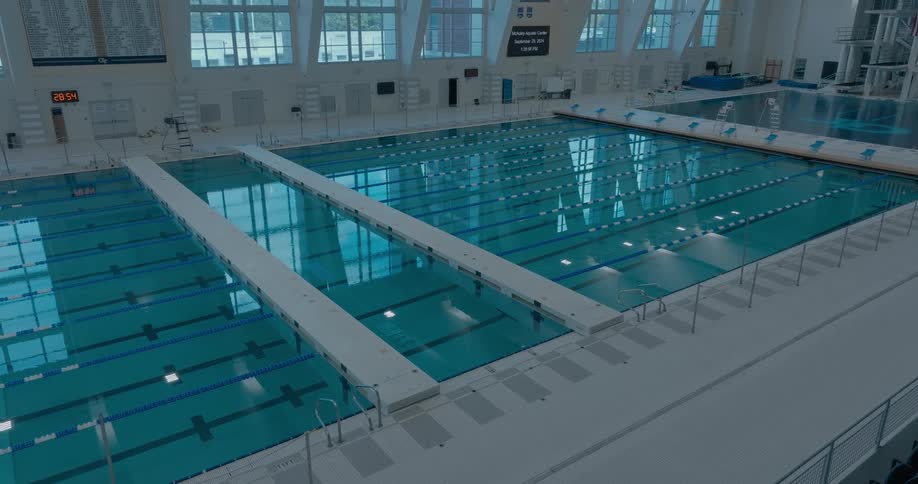 An empty indoor olympic size swimming pool in a modern facility