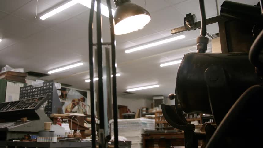 An automated printing press has a component that is moving up and down