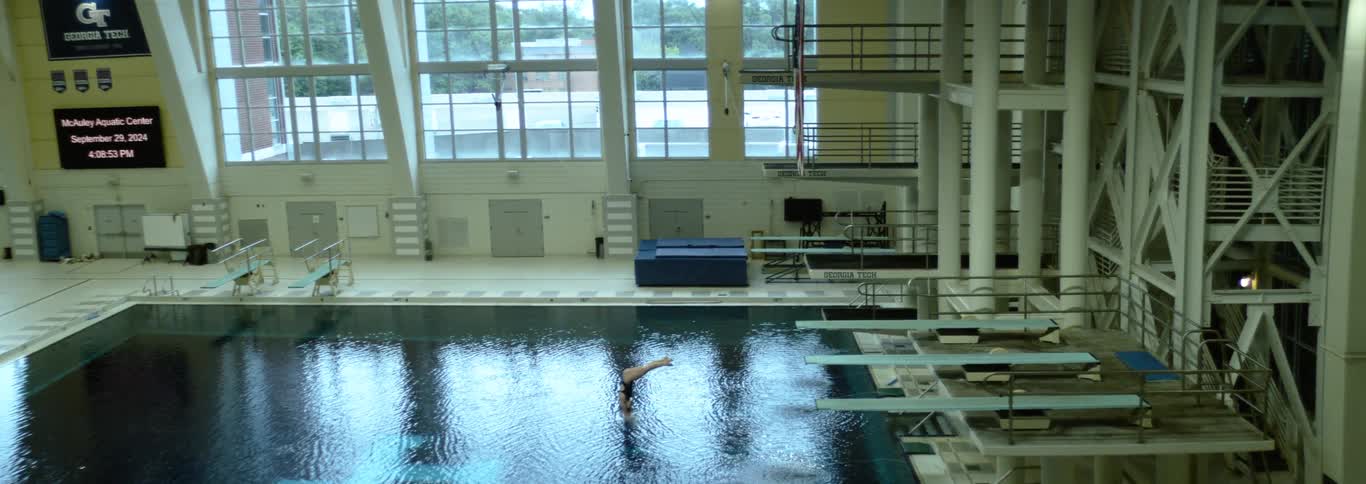 Person performs a diving jump at the mcauley aquatic center in georgia tech