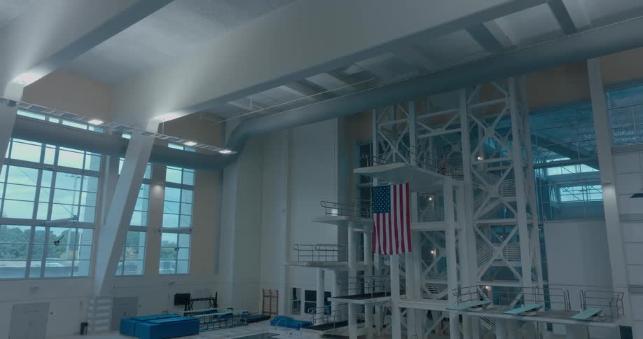 American flag hanging from high dive platform indoors