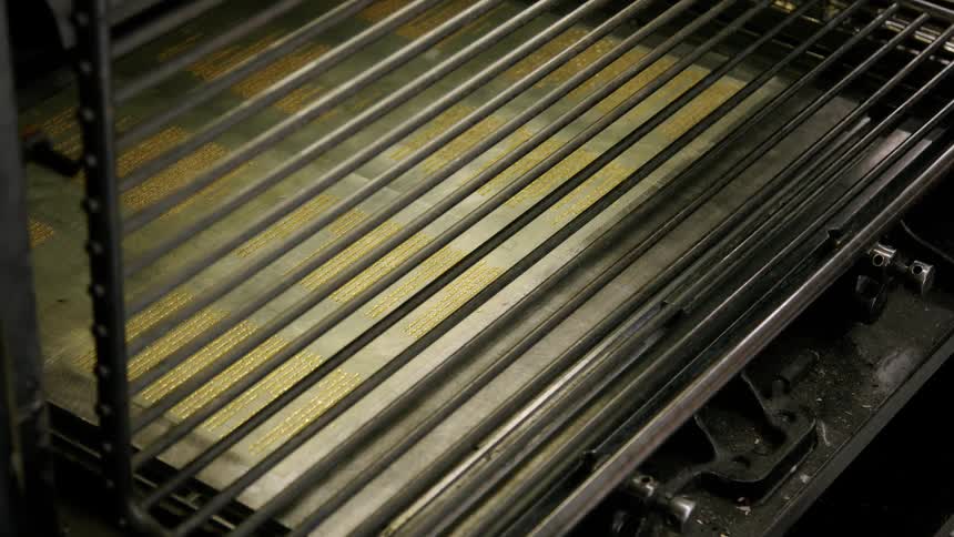 Person closes a metal grill on a machine