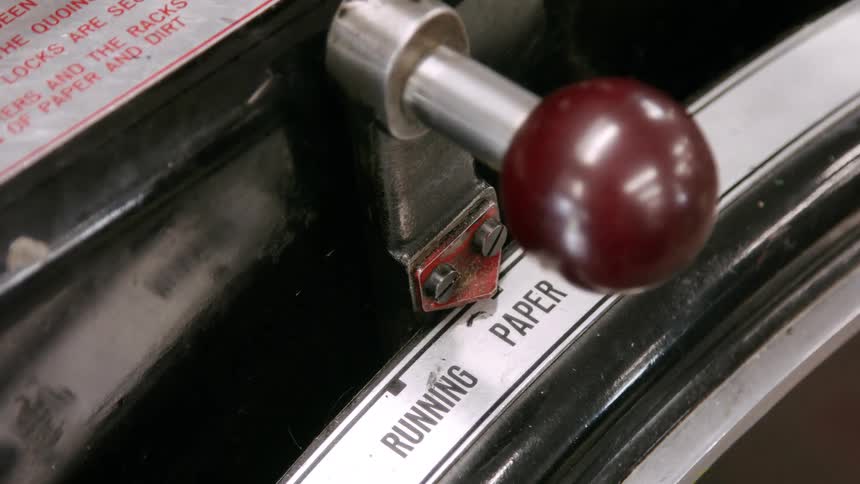 Metal lever with red knob positioned