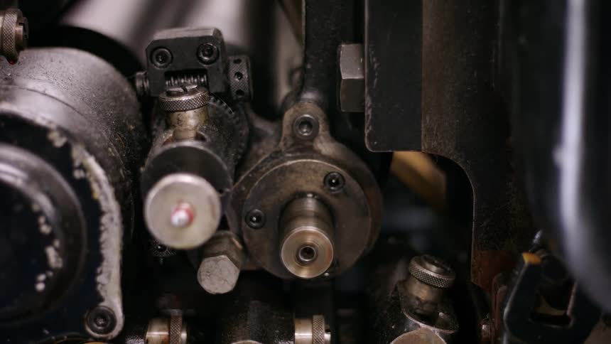 Detailed closeup shows metal gears and internal components of an industrial machine