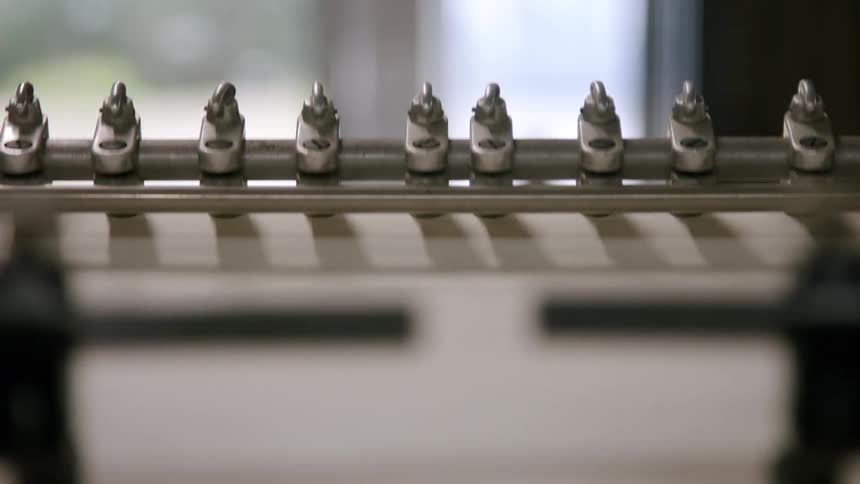 The bars on the machine feed the paper in the printing press
