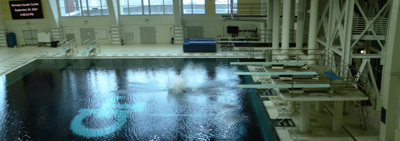 Surface of the pool at the mcauley aquatic center disturbed after a dive from the platforms
