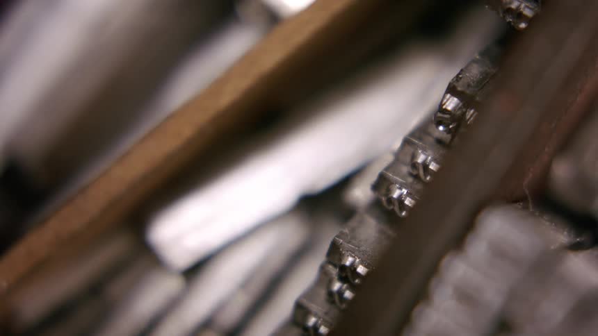 A close up of metal typeset letters for printing