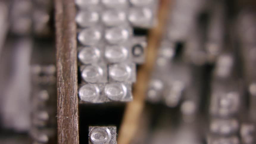 Closeup view of old metal letterpress type blocks arranged together