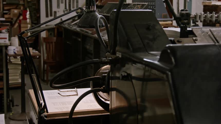 A workplace is full of printing press machinery and equipment