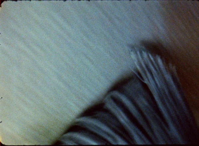 The video shows an extreme closeup of a brush being used to apply a substance the brush strokes are visible as they move from top to bottom creating a smooth fluid motion