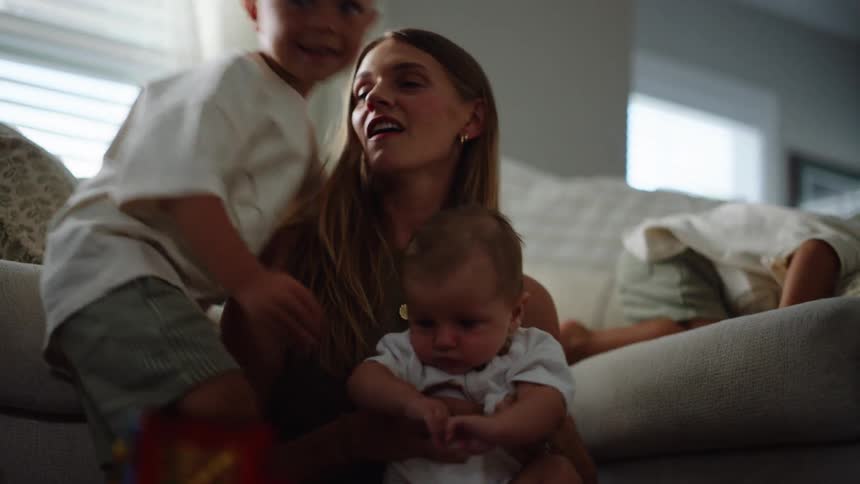 A little boy hugs his baby brother