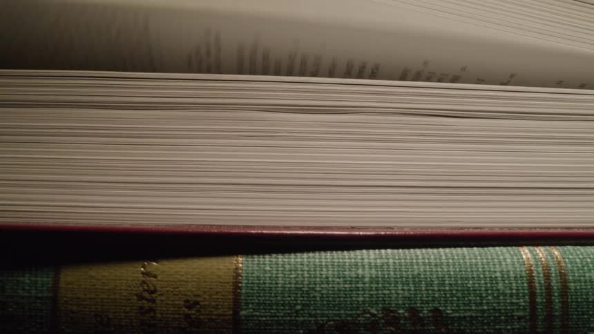 Closeup of stacked book pages highlighting the relief and textures of the edges
