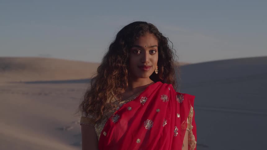 The woman is smiling in the desert