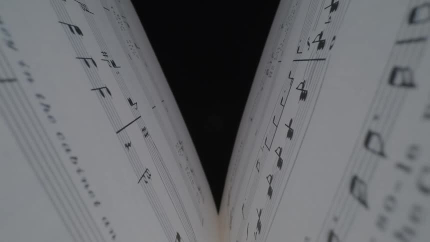 Falling between pages of sheet music