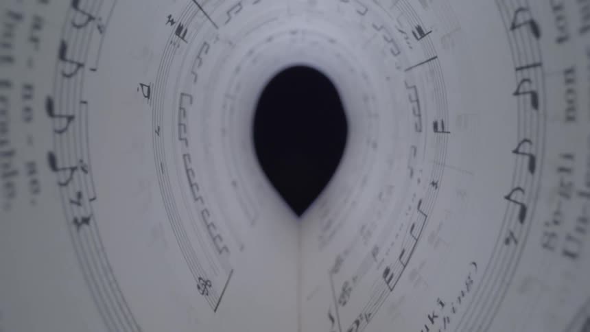 A paper tunnel with musical text written on it sides formed from pages of a musical publication