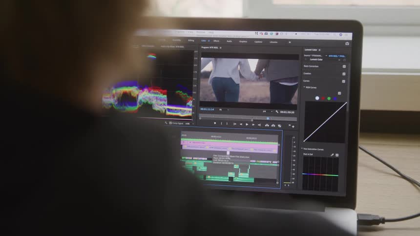 Close up of a person working on an editing software on a laptop in a room during daytime