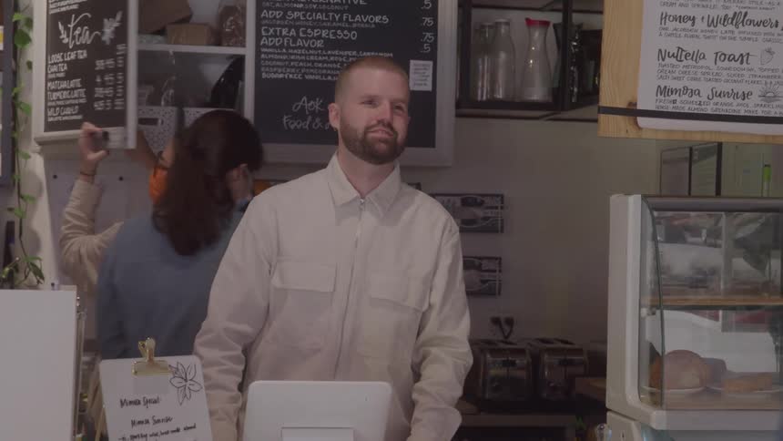Customer places an order at a coffee shop counter