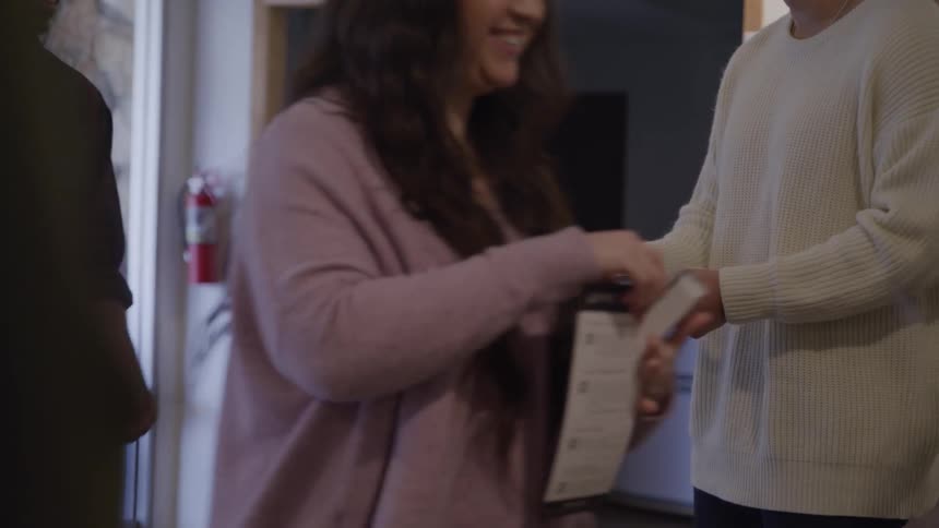 Person hands out flyers to people