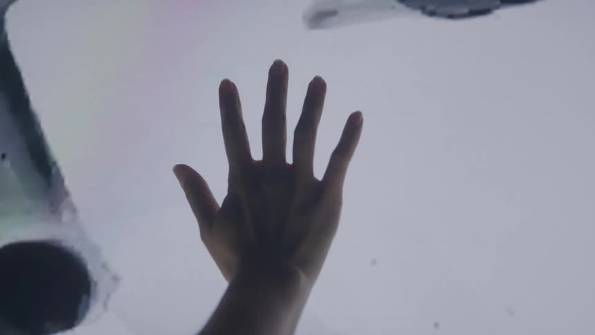 Raised hand against a light background