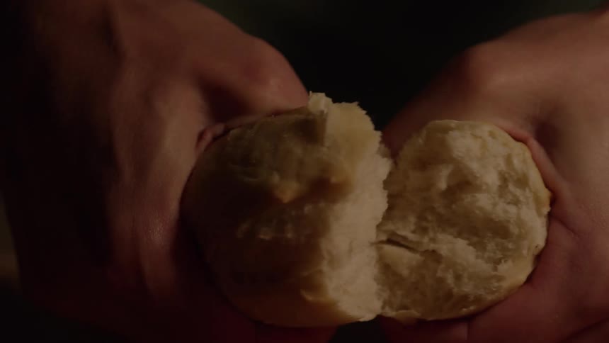 Extreme close up of fresh baked bread being split in half