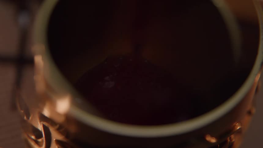 The cup is being slowly filled