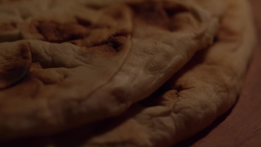 A close up of the surface texture of a stack of baked flatbread