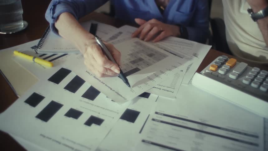 Elderly couple review paperwork together at home